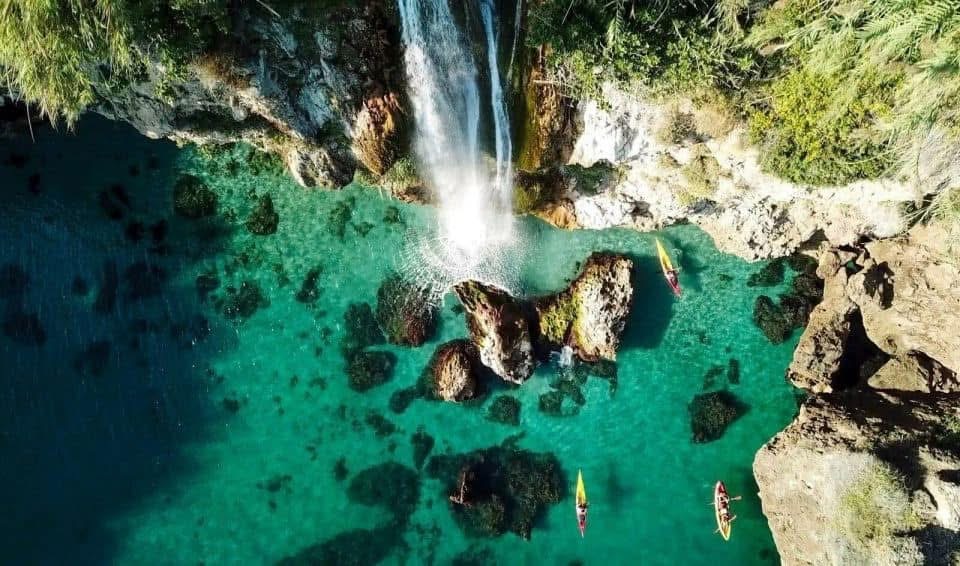 De kliffen van Maro met een waterval die in de helderblauwe zee stort